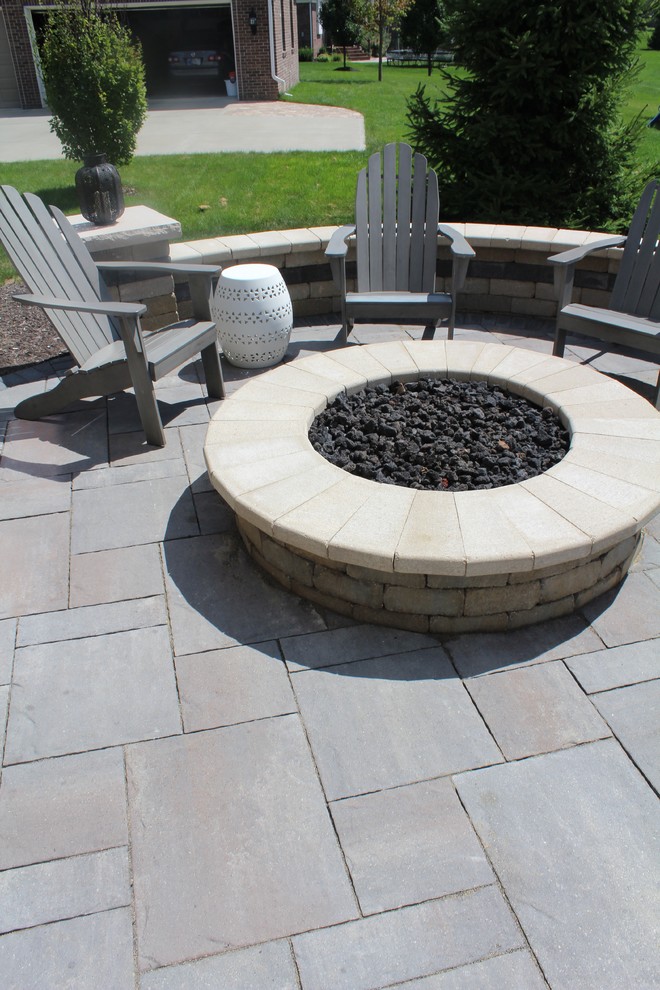 Design ideas for a small traditional back patio in Indianapolis with a fire feature, brick paving and no cover.