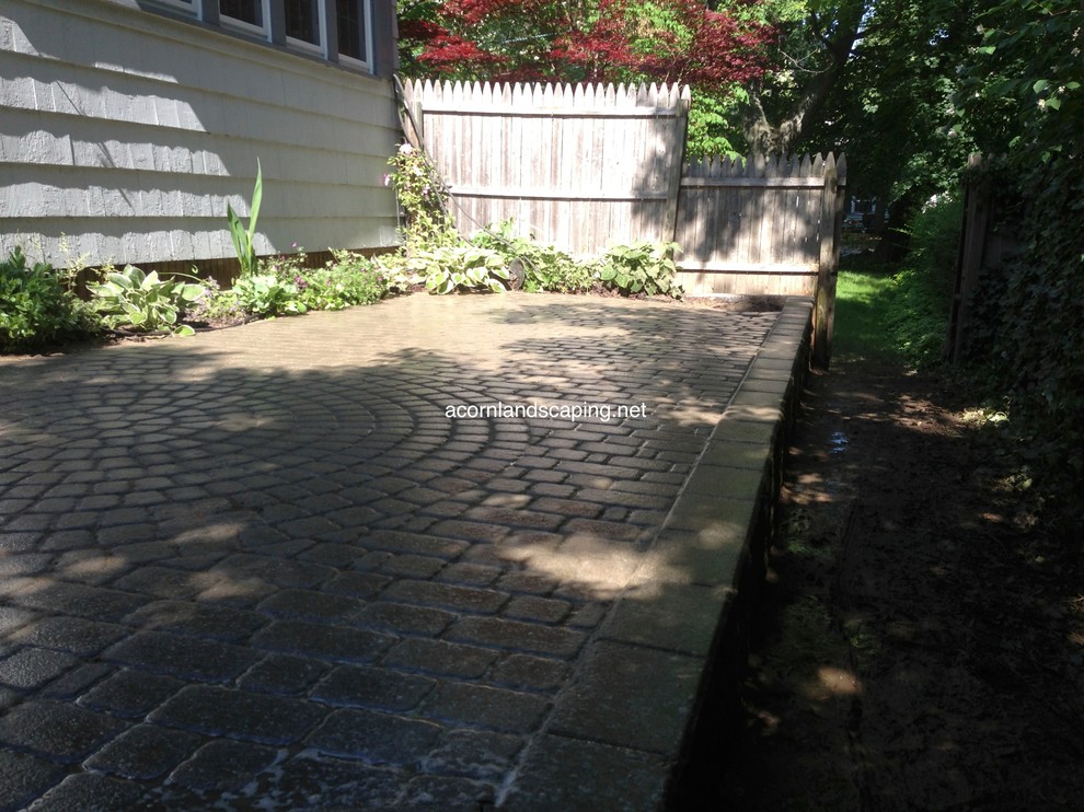 Inspiration for a small timeless backyard concrete paver patio remodel in New York