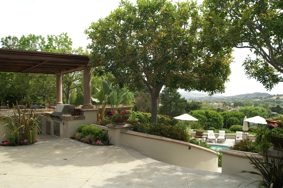 Inspiration for an expansive mediterranean back patio in Orange County with a potted garden, concrete paving and a gazebo.