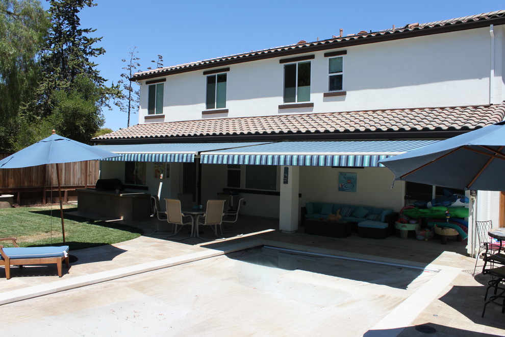 Пример оригинального дизайна: большой двор на заднем дворе в стиле модернизм с летней кухней, покрытием из каменной брусчатки и козырьком