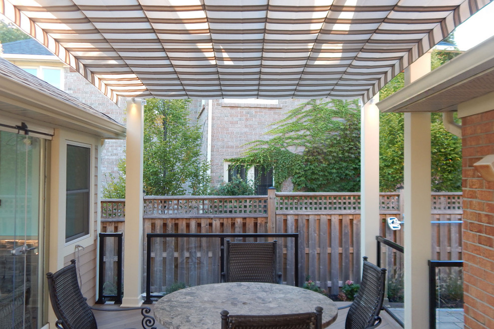 Inspiration for a classic back patio in Toronto with decking and a pergola.