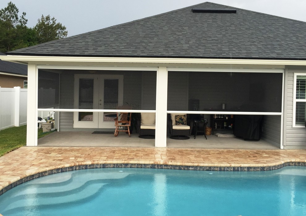 Mid-sized elegant backyard concrete patio photo in Jacksonville with a roof extension