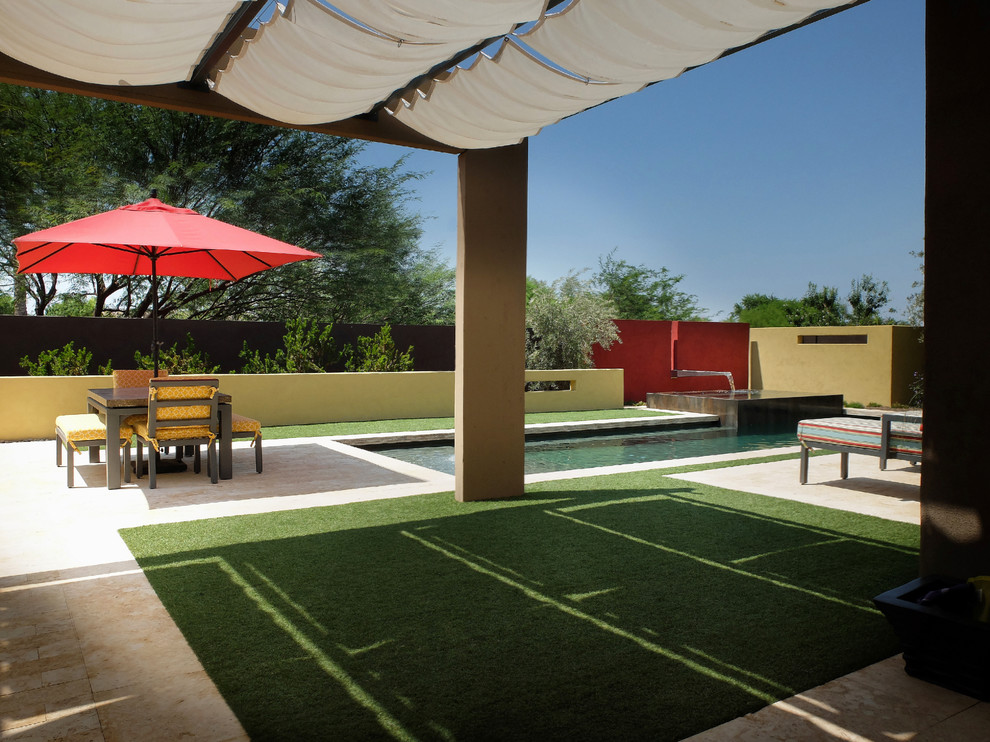 Medium sized contemporary back patio in Phoenix with a water feature, tiled flooring and an awning.