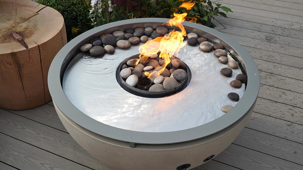 Patio - mid-sized contemporary patio idea in Surrey with a fire pit