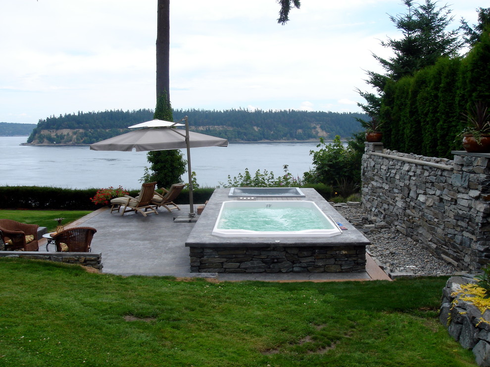 Traditional back patio in Seattle with a water feature and no cover.
