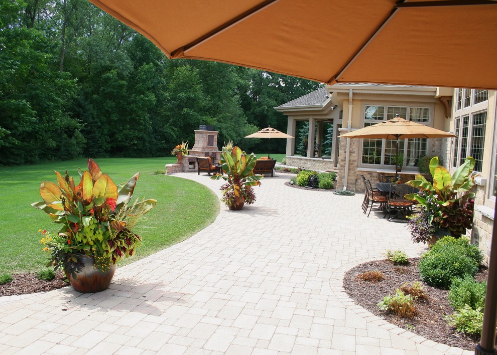 Patio - large mediterranean backyard brick patio idea in Other with no cover