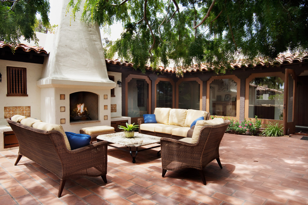 Tuscan brick patio photo in San Diego with a fire pit and no cover