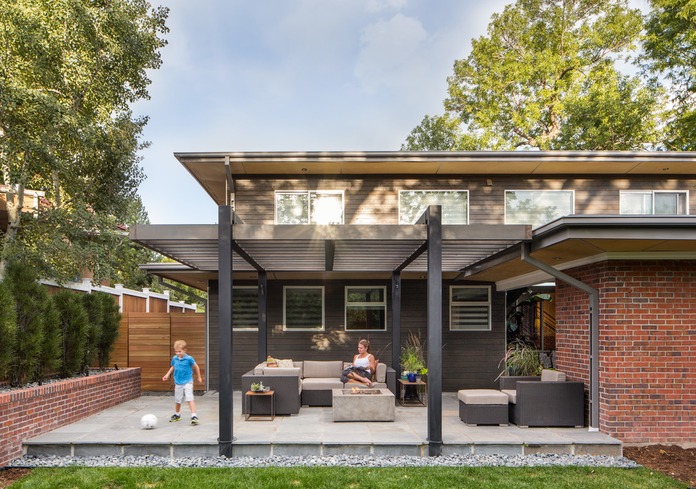 Inspiration for a medium sized contemporary back patio in Denver with a pergola.