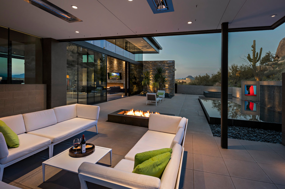 This is an example of a contemporary patio in Phoenix with a fire feature.