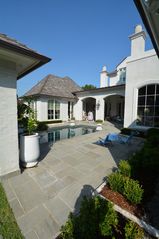 Example of a mid-sized trendy backyard tile patio design in New Orleans with a gazebo