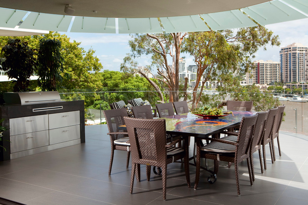 Design ideas for a contemporary patio in Brisbane with tiled flooring and a roof extension.