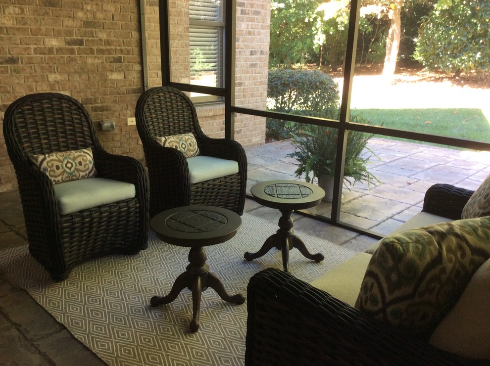 Photo of a traditional side patio in Charlotte with stamped concrete and a pergola.