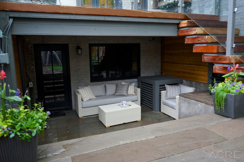 Example of a trendy backyard patio design in Toronto with decking