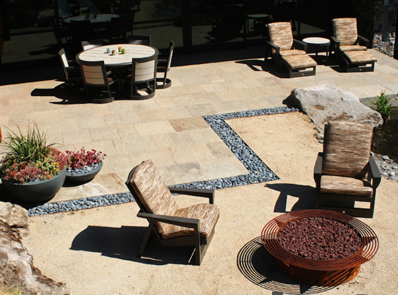 Patio - large contemporary backyard stone patio idea in Portland with a fire pit and a roof extension
