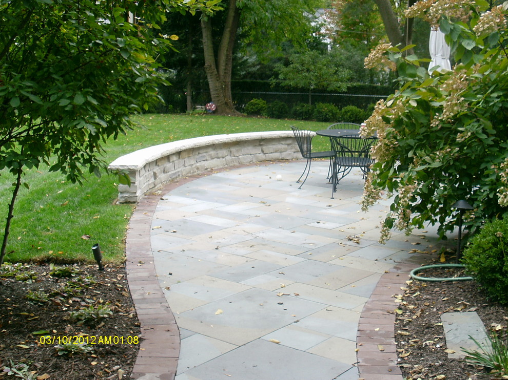 Riverside seating wall Traditional Patio Chicago by Lofton