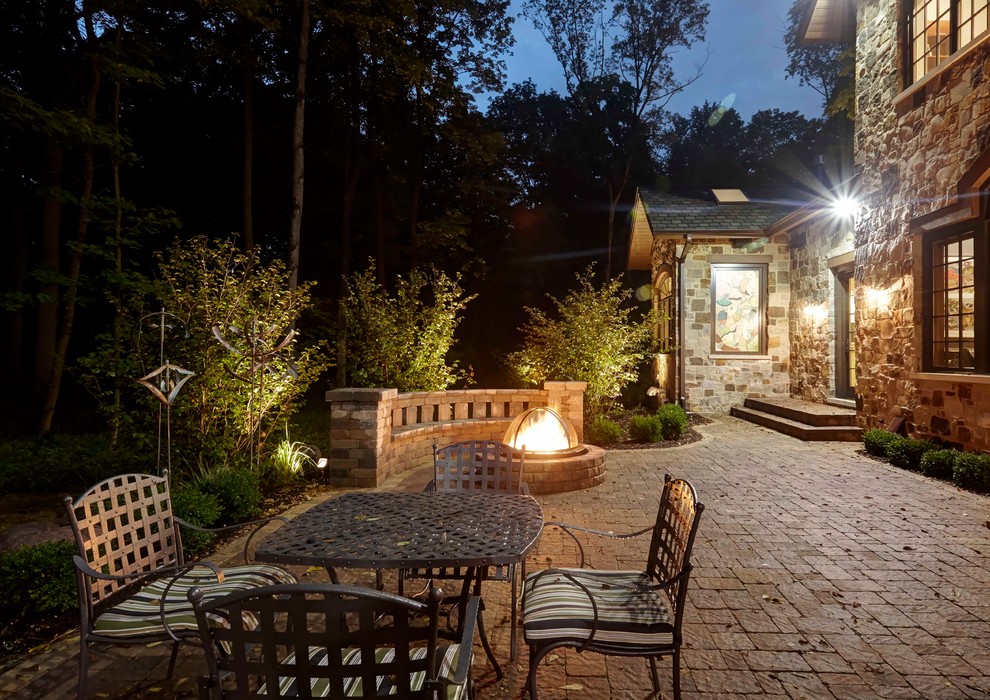 Patio - huge traditional backyard brick patio idea in Chicago with a fire pit and no cover