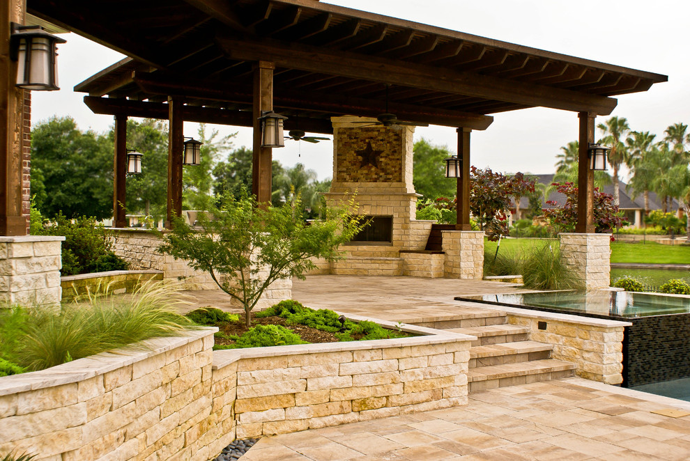 Design ideas for an expansive traditional back patio in Houston with a fire feature, tiled flooring and no cover.