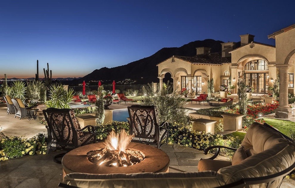 Large tuscan backyard patio fountain photo in Phoenix with decking and a gazebo