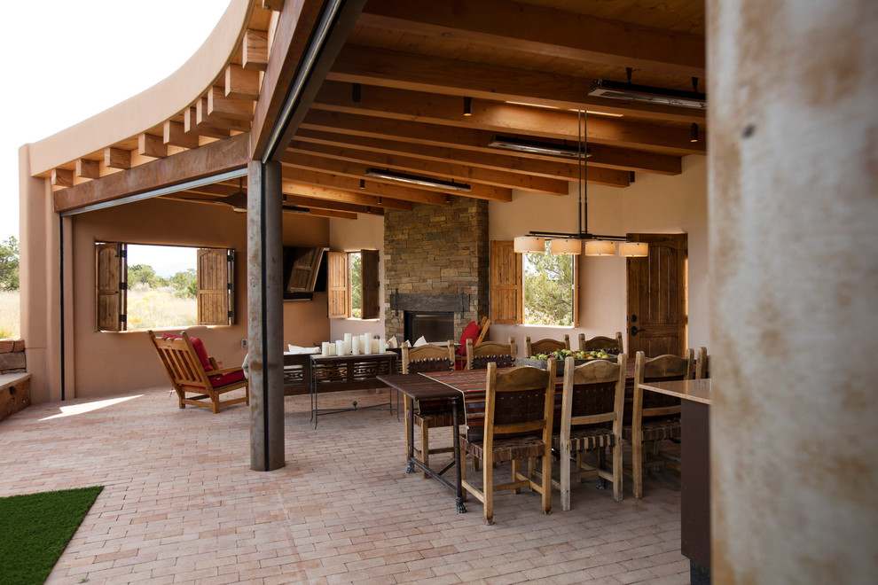 Großer, Überdachter Moderner Patio hinter dem Haus mit Outdoor-Küche und Pflastersteinen in Albuquerque