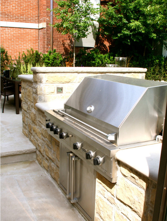 Patio kitchen - large traditional backyard concrete patio kitchen idea in Toronto with no cover