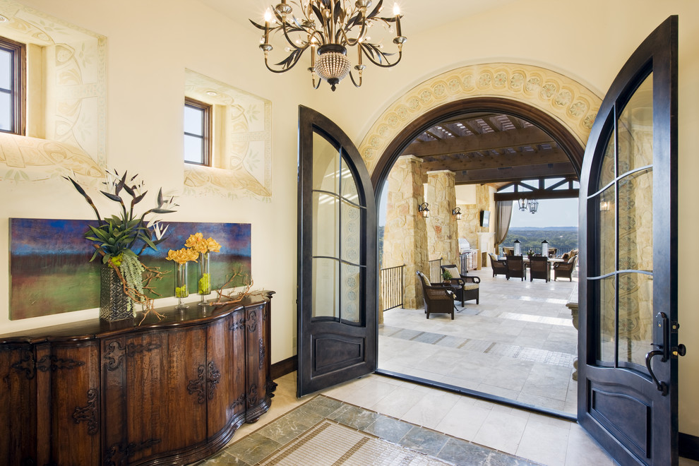 Example of a tuscan patio design in Austin with a pergola