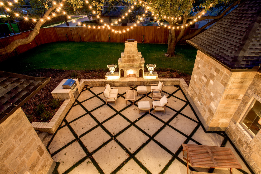Photo of a large traditional courtyard patio in Dallas with a fire feature and decomposed granite.
