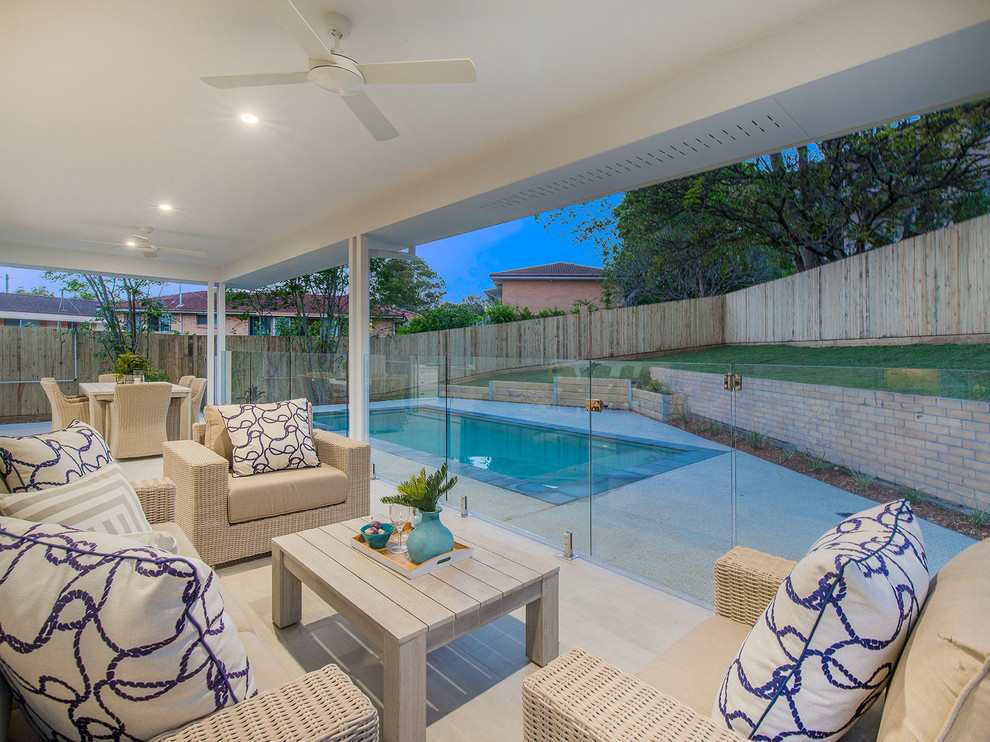 Photo of a medium sized beach style back patio in Brisbane with tiled flooring.