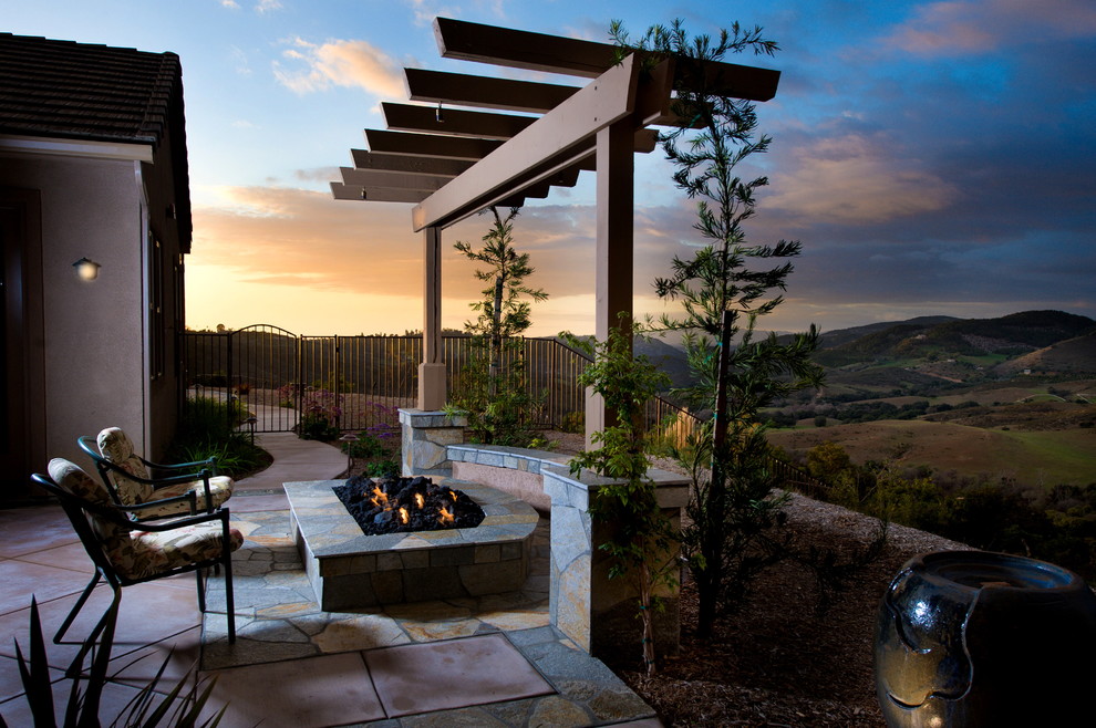 Example of a classic patio design in San Diego with a fire pit