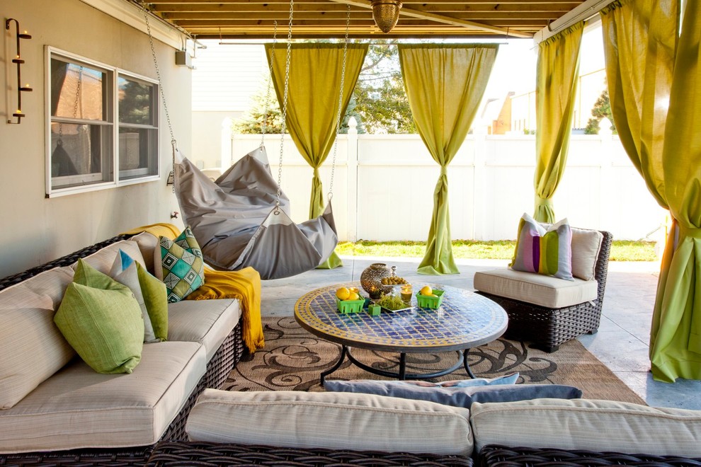 Inspiration for an eclectic backyard patio remodel in New York with a fire pit