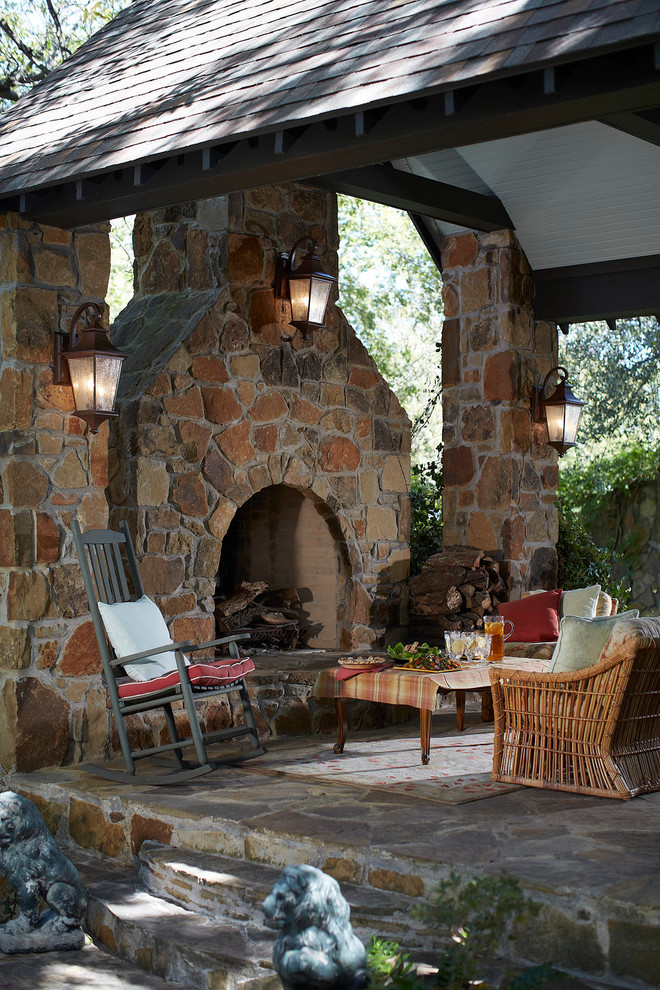 This is an example of a small rustic back patio in New York with a fire feature, natural stone paving and a gazebo.