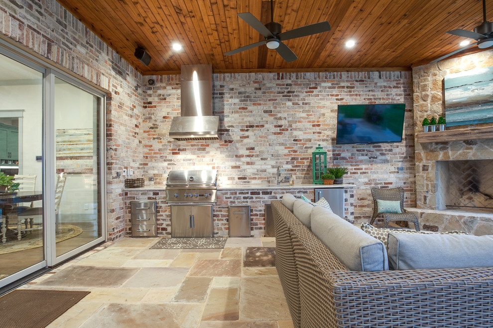 This is an example of a large rustic back patio in Dallas with an outdoor kitchen, tiled flooring and a roof extension.