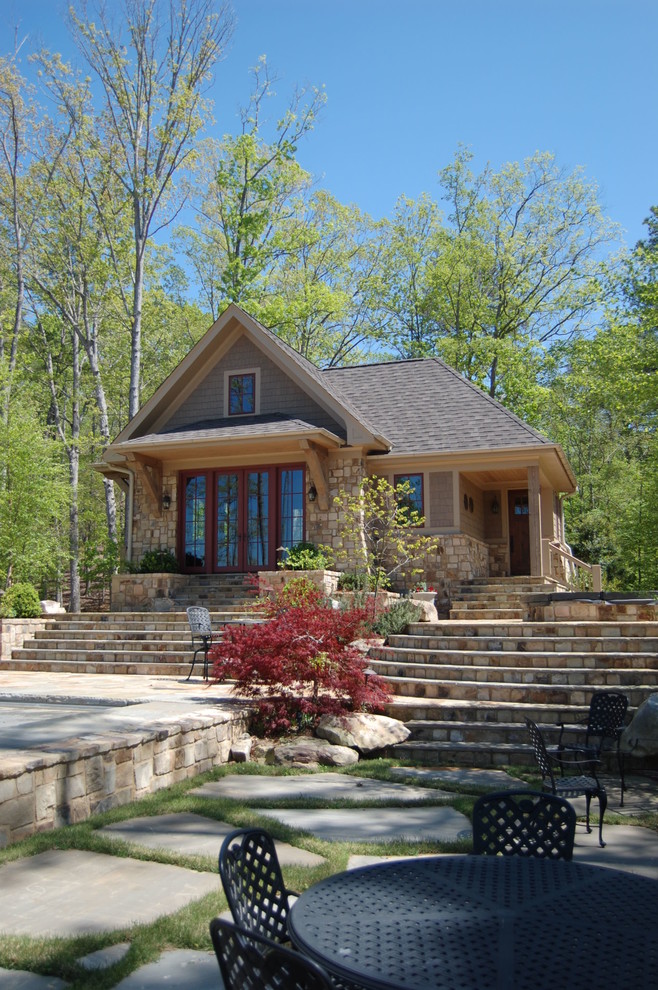 Inspiration for a mid-sized rustic backyard stone patio remodel in Atlanta with no cover