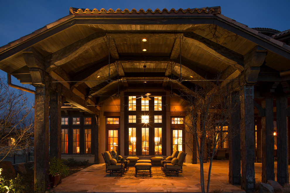 Photo of a rustic patio in Houston with a roof extension.