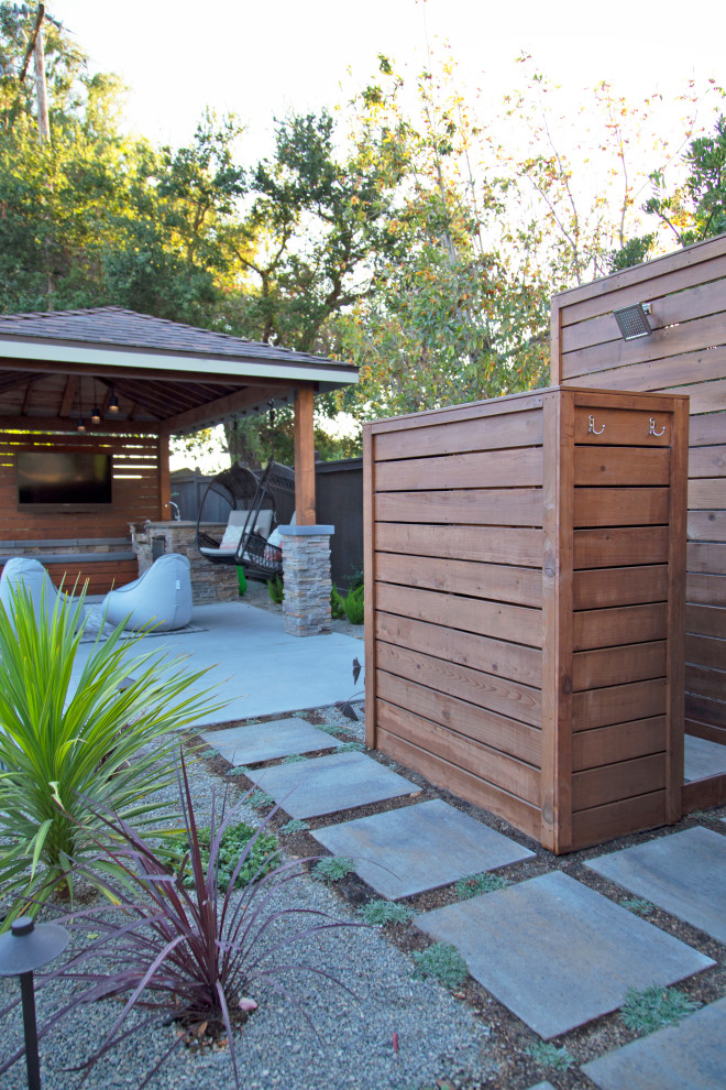 Diseño de patio minimalista grande en patio trasero con ducha exterior, adoquines de hormigón y cenador