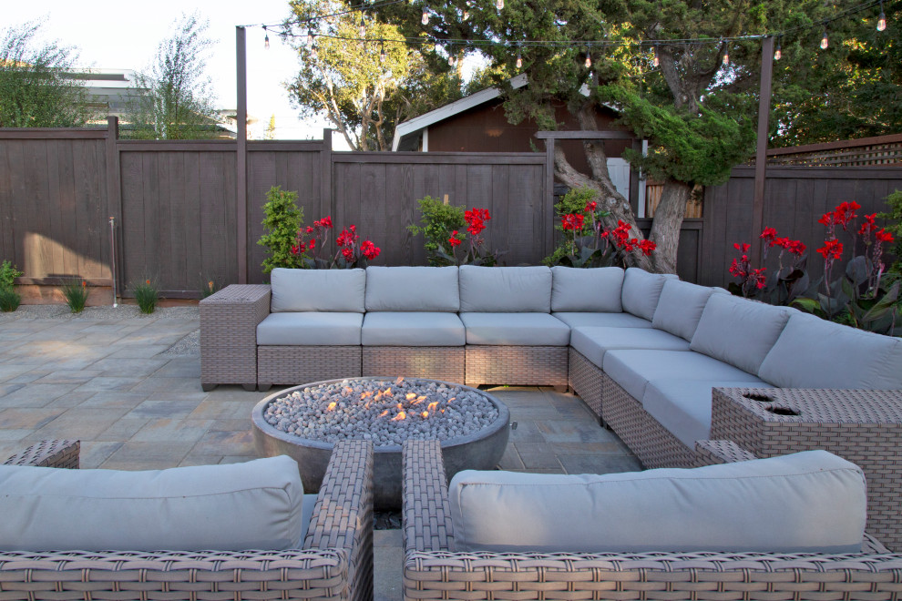 Inspiration for a large modern backyard concrete paver patio remodel in San Luis Obispo with a fire pit and a gazebo