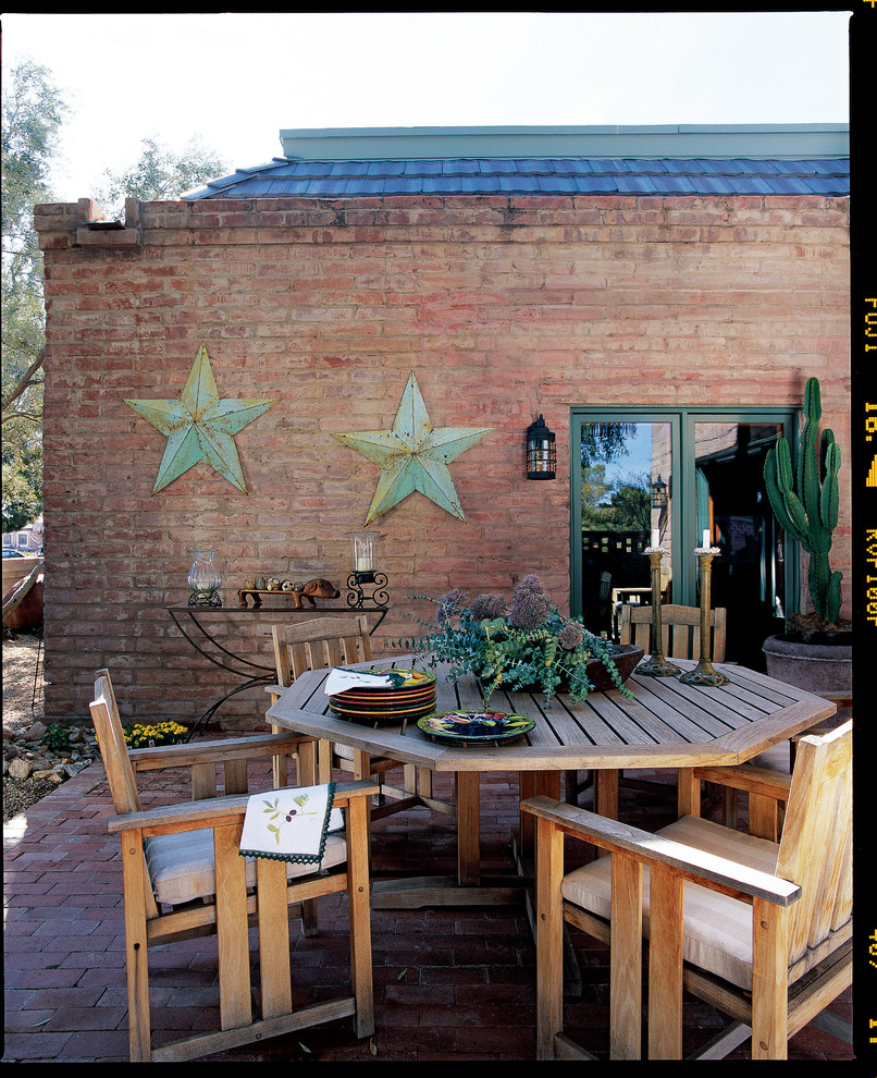 Example of a mountain style brick patio design in Phoenix with no cover