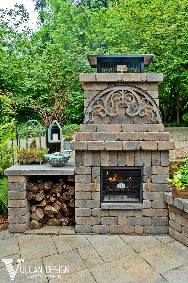 Patio - mid-sized rustic backyard brick patio idea in Portland with a fireplace and an awning