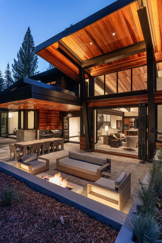 Photo of a rustic patio in Sacramento with concrete paving and a roof extension.