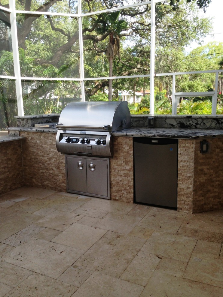 Example of a mid-sized trendy backyard stone patio kitchen design in Tampa