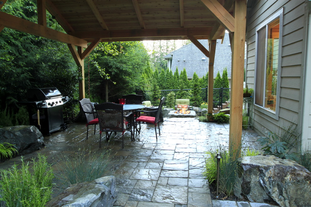 Imagen de patio clásico de tamaño medio en patio trasero con adoquines de piedra natural y cenador