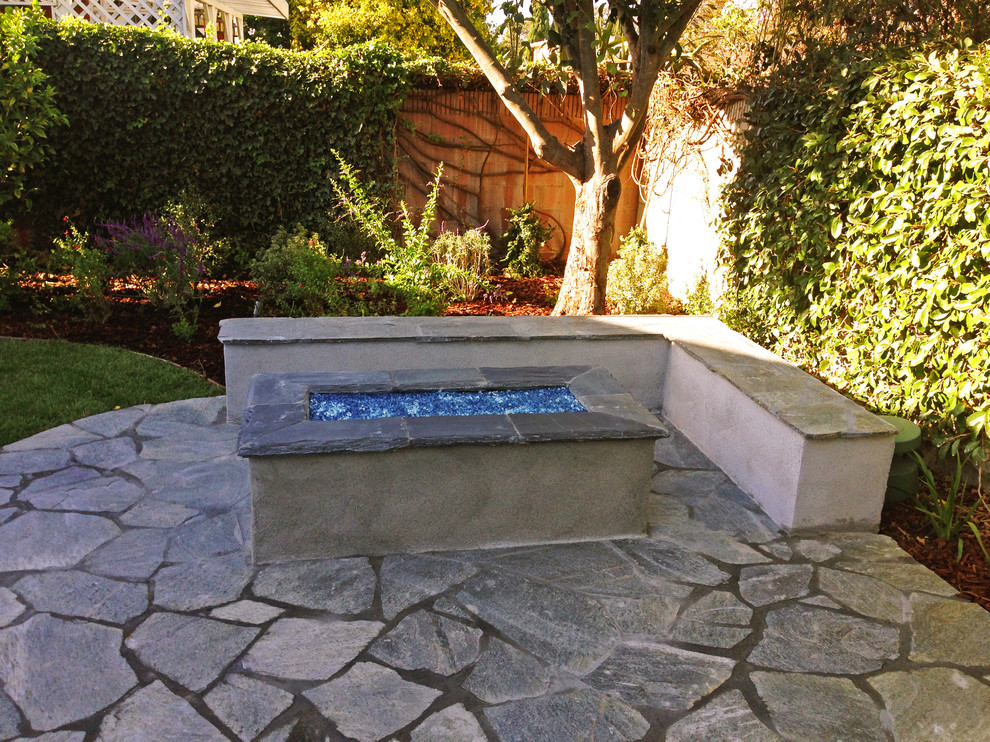 Example of a mid-sized transitional backyard concrete patio design in Orange County with a fire pit and no cover