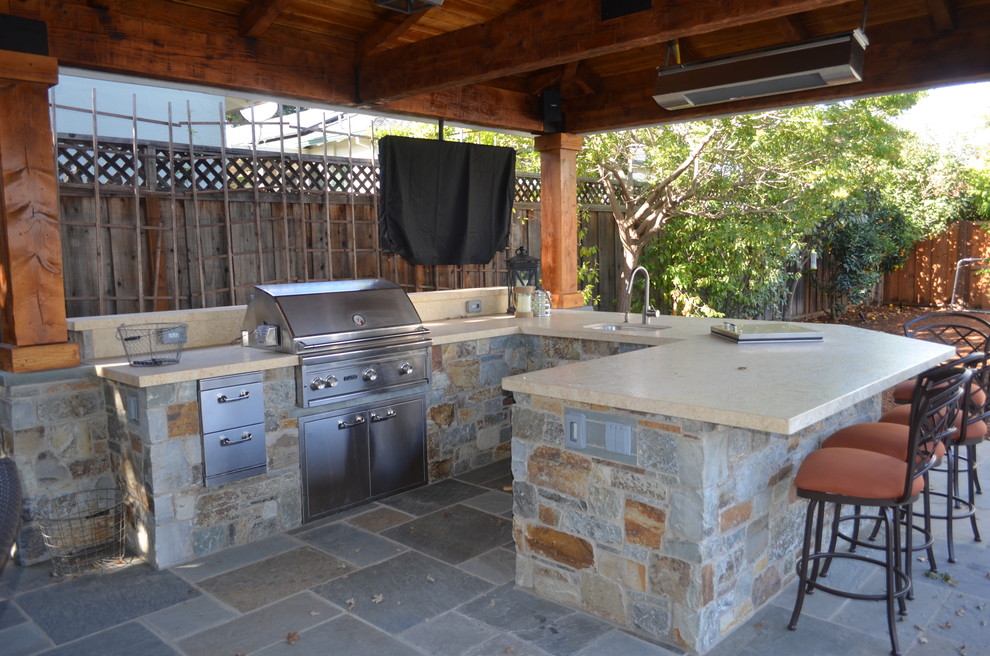 Patio kitchen - large craftsman backyard stone patio kitchen idea in San Francisco with a gazebo