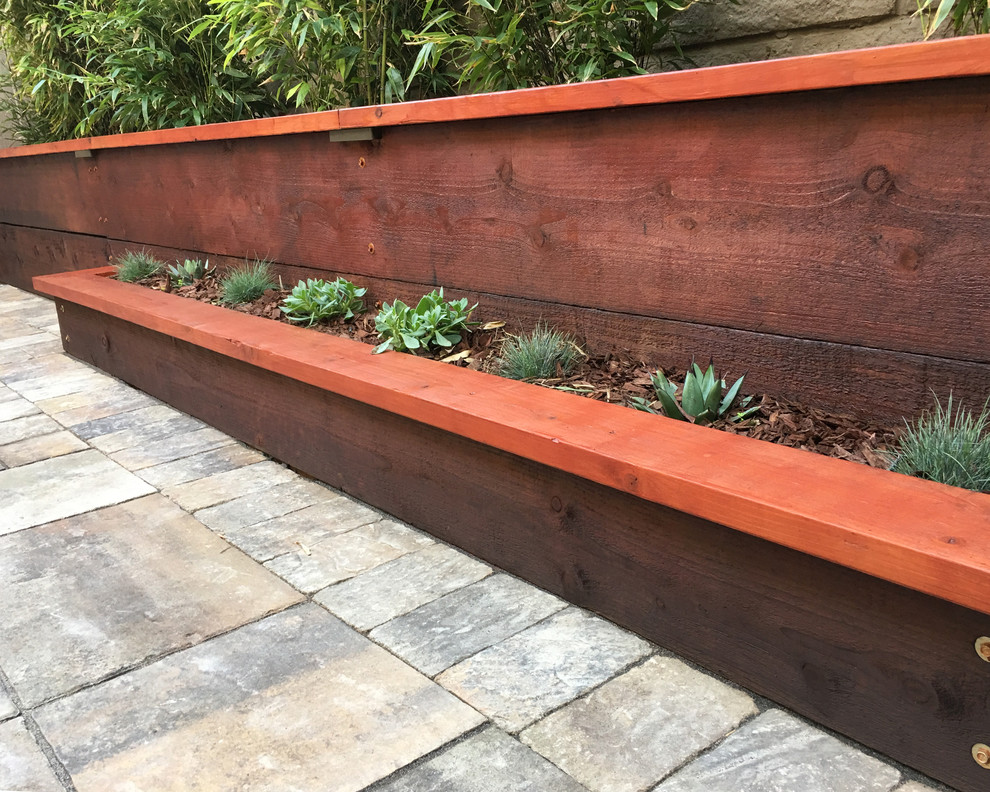 Patio container garden - mid-sized transitional backyard brick patio container garden idea in San Francisco with no cover