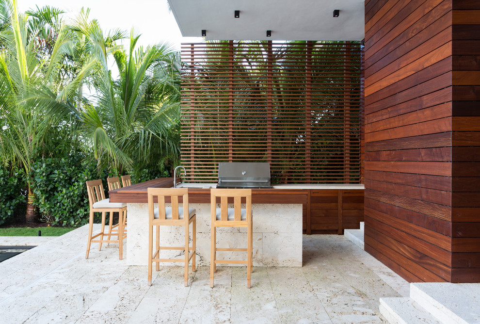 Inspiration for a medium sized contemporary back patio in Miami with an outdoor kitchen, tiled flooring and a roof extension.