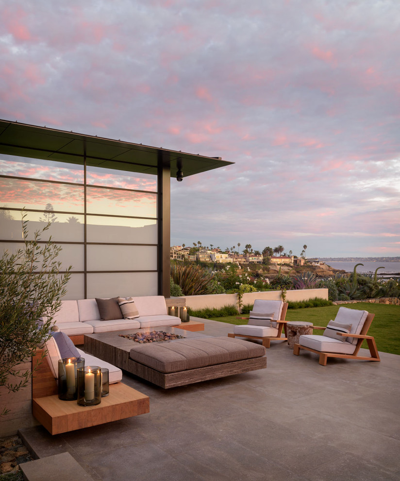 This is an example of a modern patio in San Diego with a fire feature and no cover.