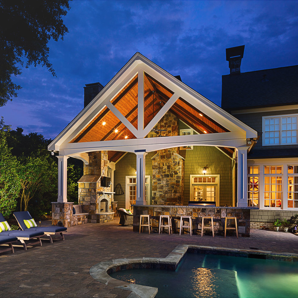 Inspiration for a large timeless backyard brick patio remodel in Atlanta with a fireplace and a roof extension