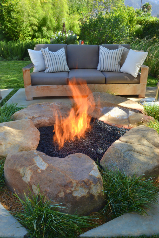 Design ideas for a contemporary back patio in San Luis Obispo with a fire feature.