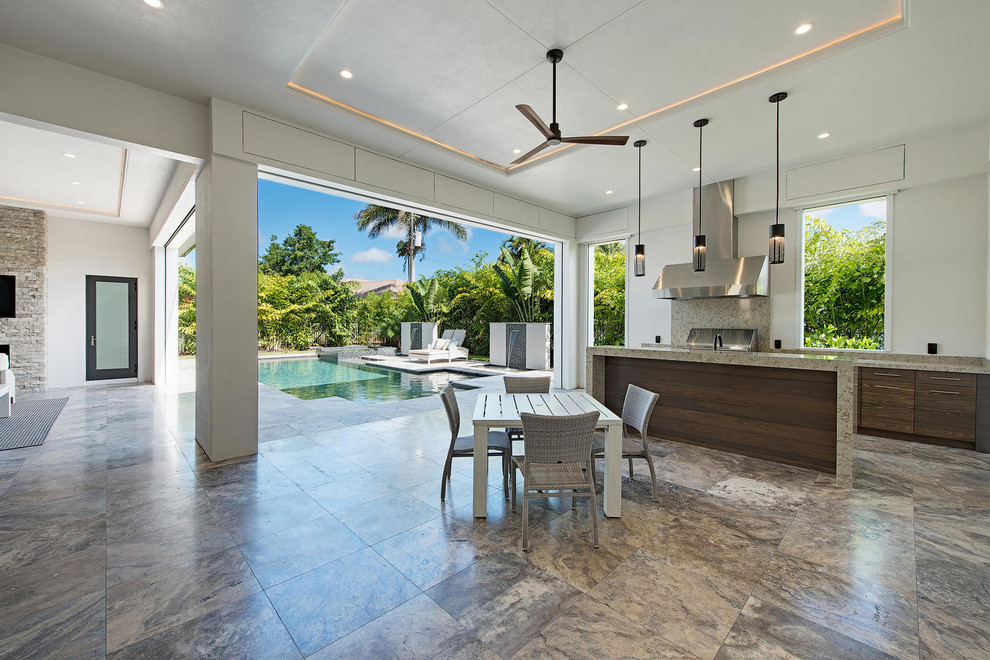 Example of a large trendy backyard concrete paver patio kitchen design in Other with a roof extension