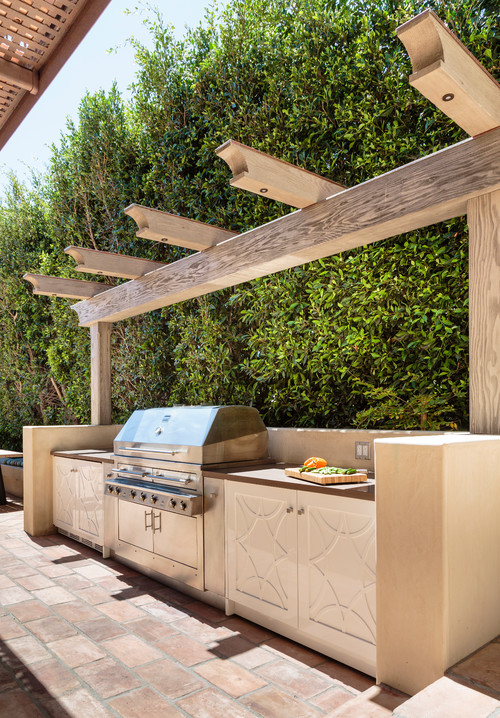 Enhance Outdoor Spaces with White Outdoor Kitchen Cabinets and a Wood Pergola