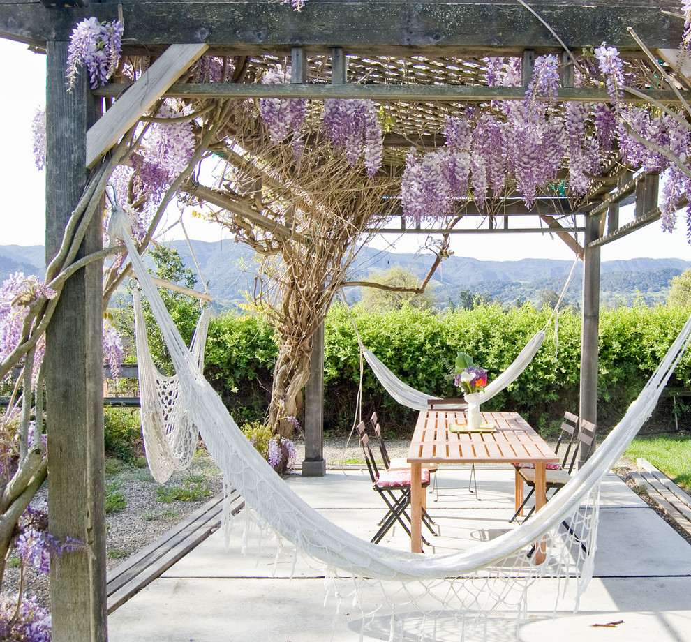 Inspiration for a farmhouse backyard patio remodel in Santa Barbara with a pergola
